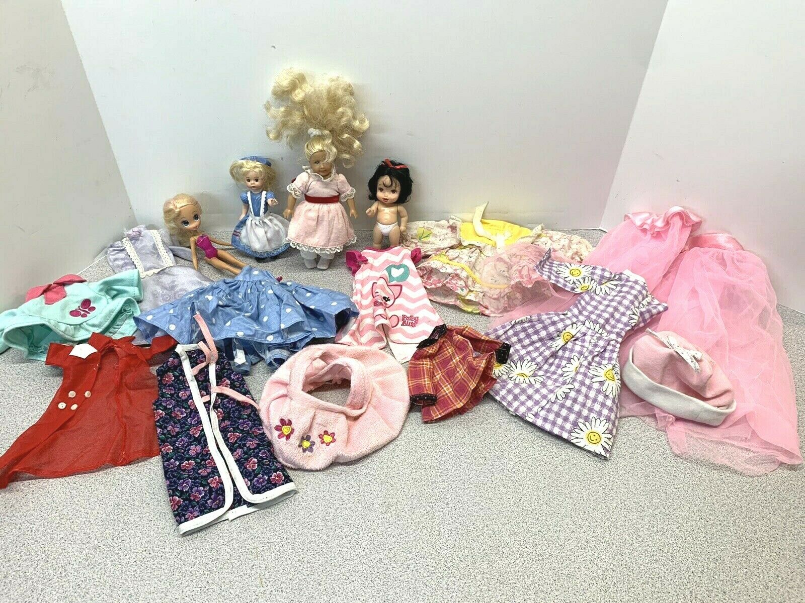 Large Assortment of Small Dolls and Doll Clothes        (C21)